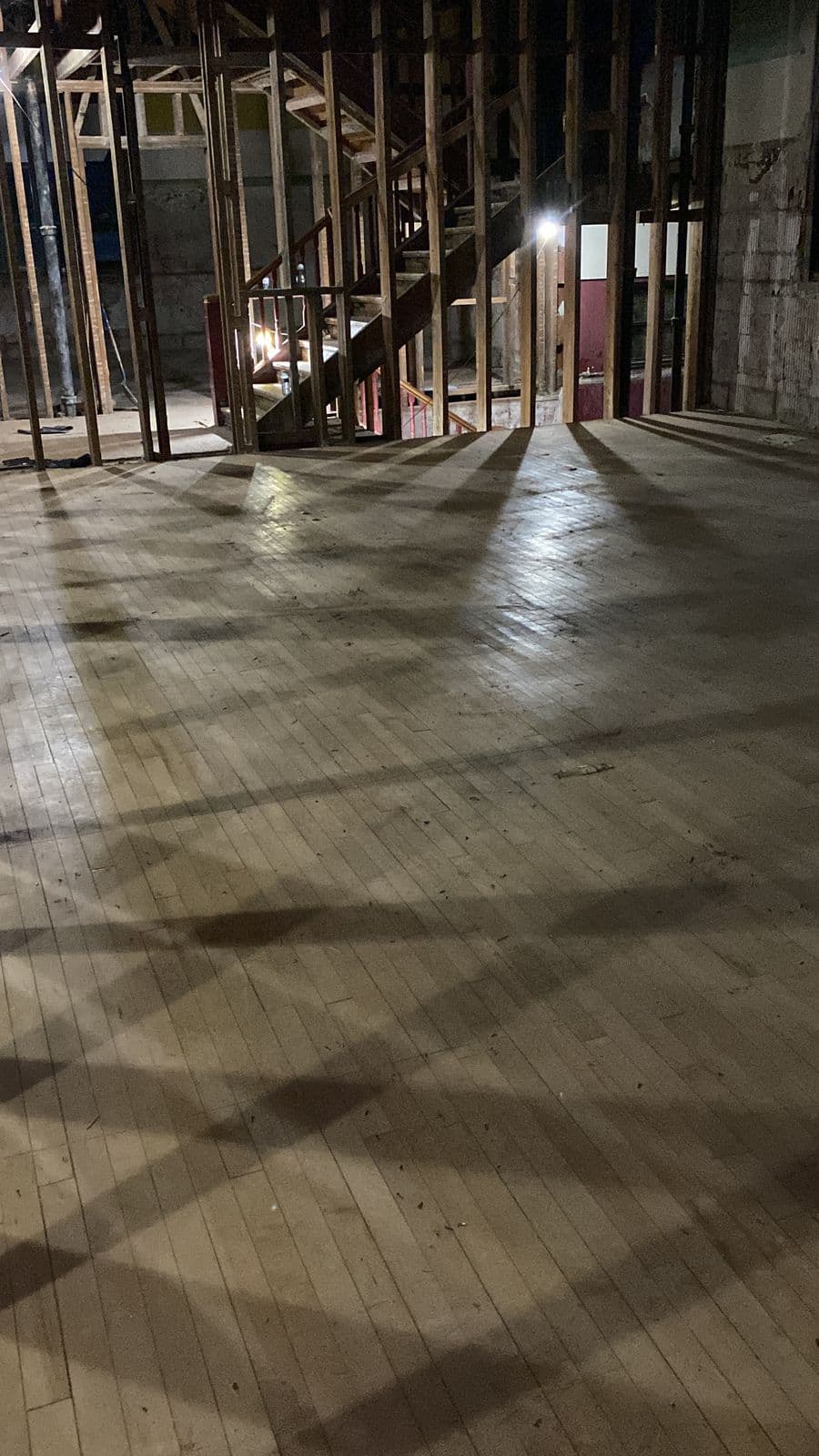 Long school floor cleared to clean boards after tile removal